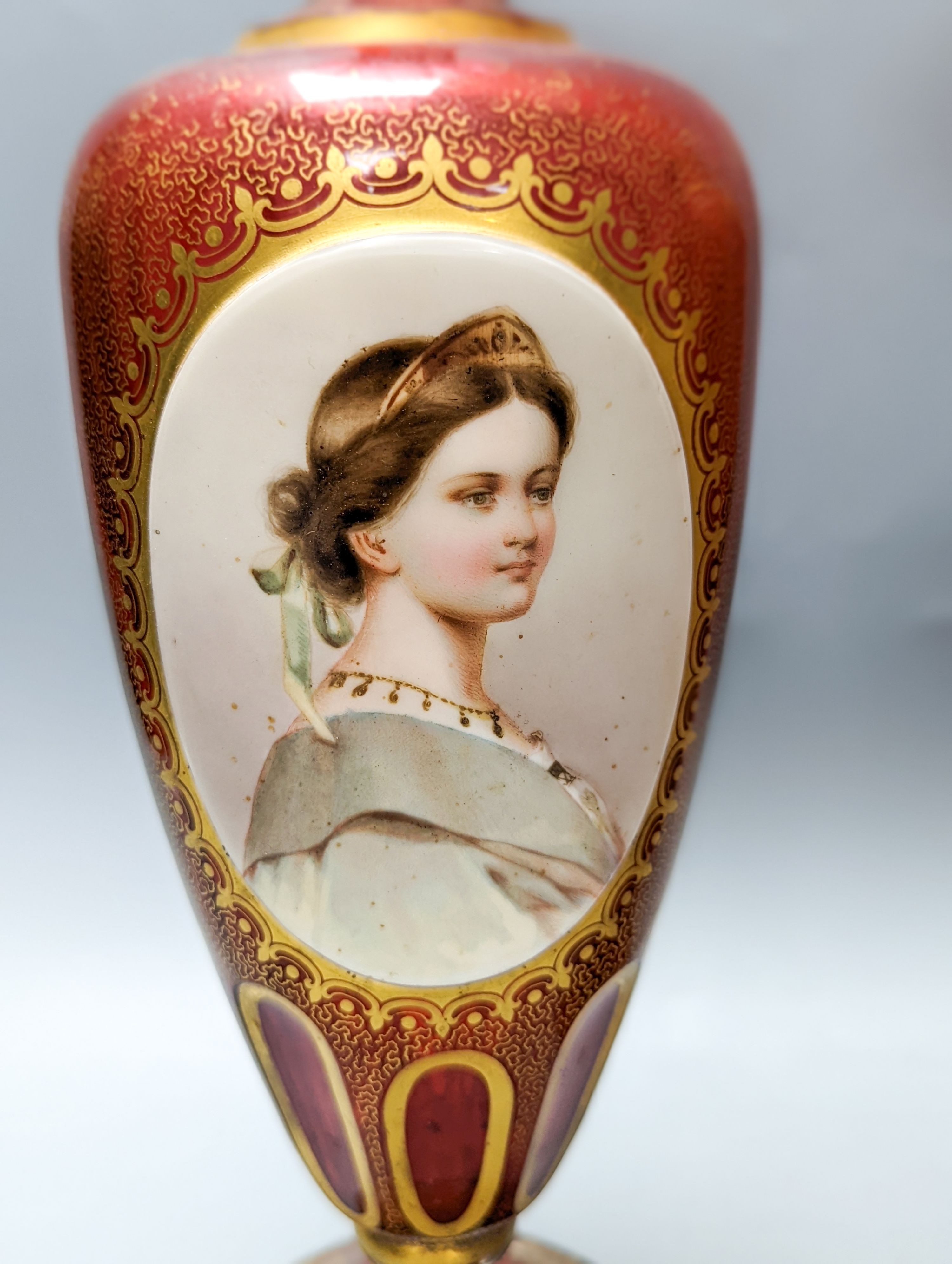 A pair of Bohemian enamelled and overlaid cranberry glass vases, 19th century 35cm